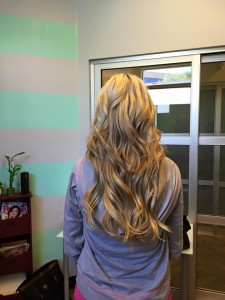 This photo shows how the halo blends so well into your own hair. This halo beauty is wearing a 16" layered halo in the color 14/24. It pops the lowlights in her hair out and blends into a natural looking blonde instead of a solid blonde that could look a little gold, brassy, or ashy in another extension line.